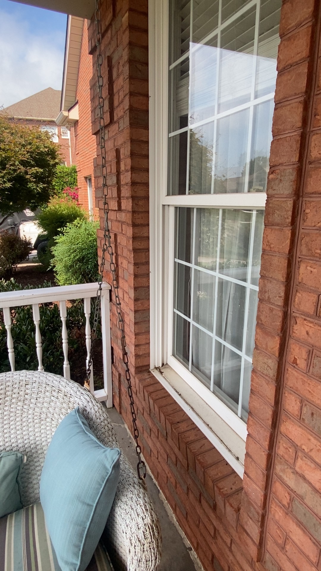Clean windows beside a covered porch swing