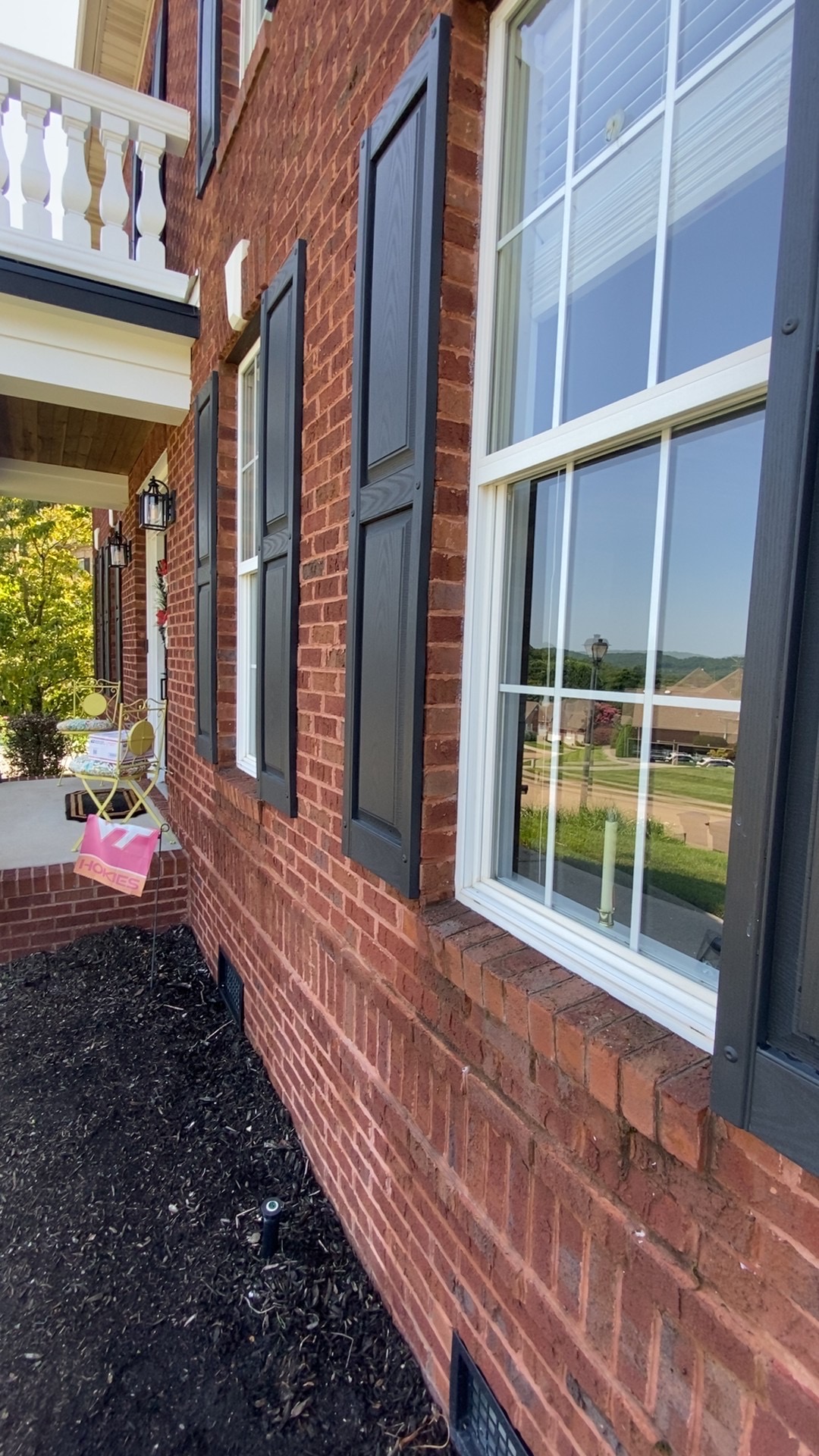 Brick home with freshly cleaned windows and shutters